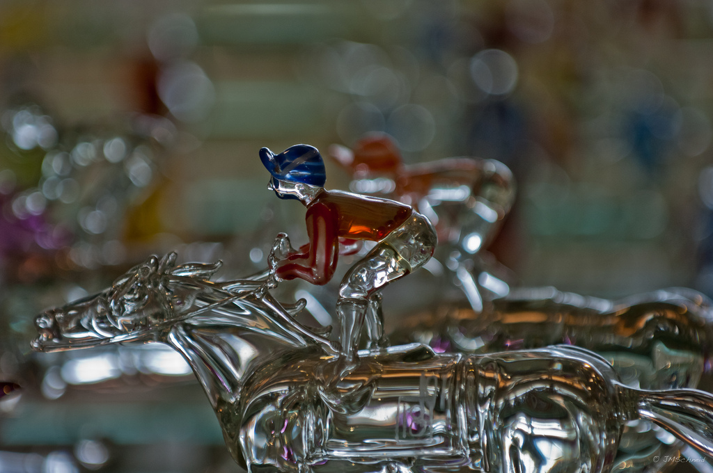 Close-up glass jockey and racehorse sculpture