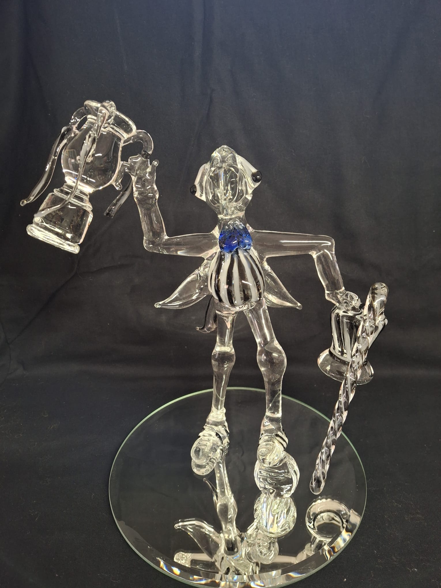 Glass trophy figure sculpture holding two trophies